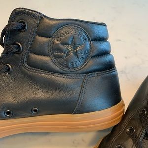 Black leather, rubber sole, high top Converse. Extremely rare find